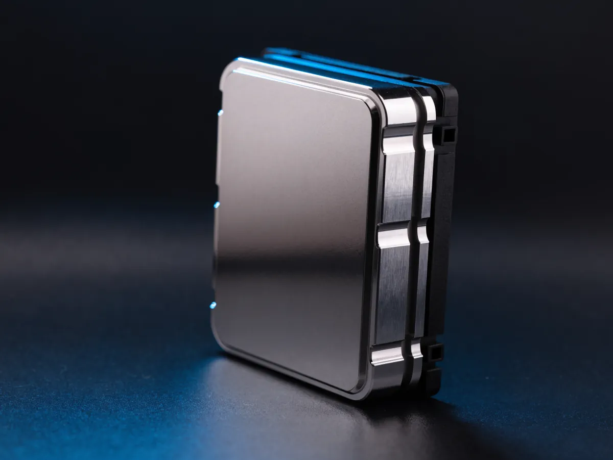 Very large rectangular server processor held upright in a plain black plastic carrier frame with a blue rim light along its top edge