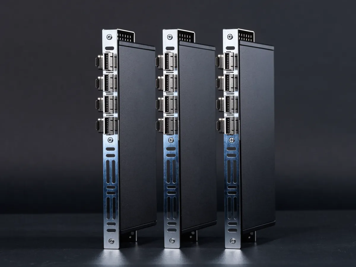 Three full height passive server graphics cards standing upright with their bracket plates facing the camera, each carrying a vertical column of four DisplayPort sockets