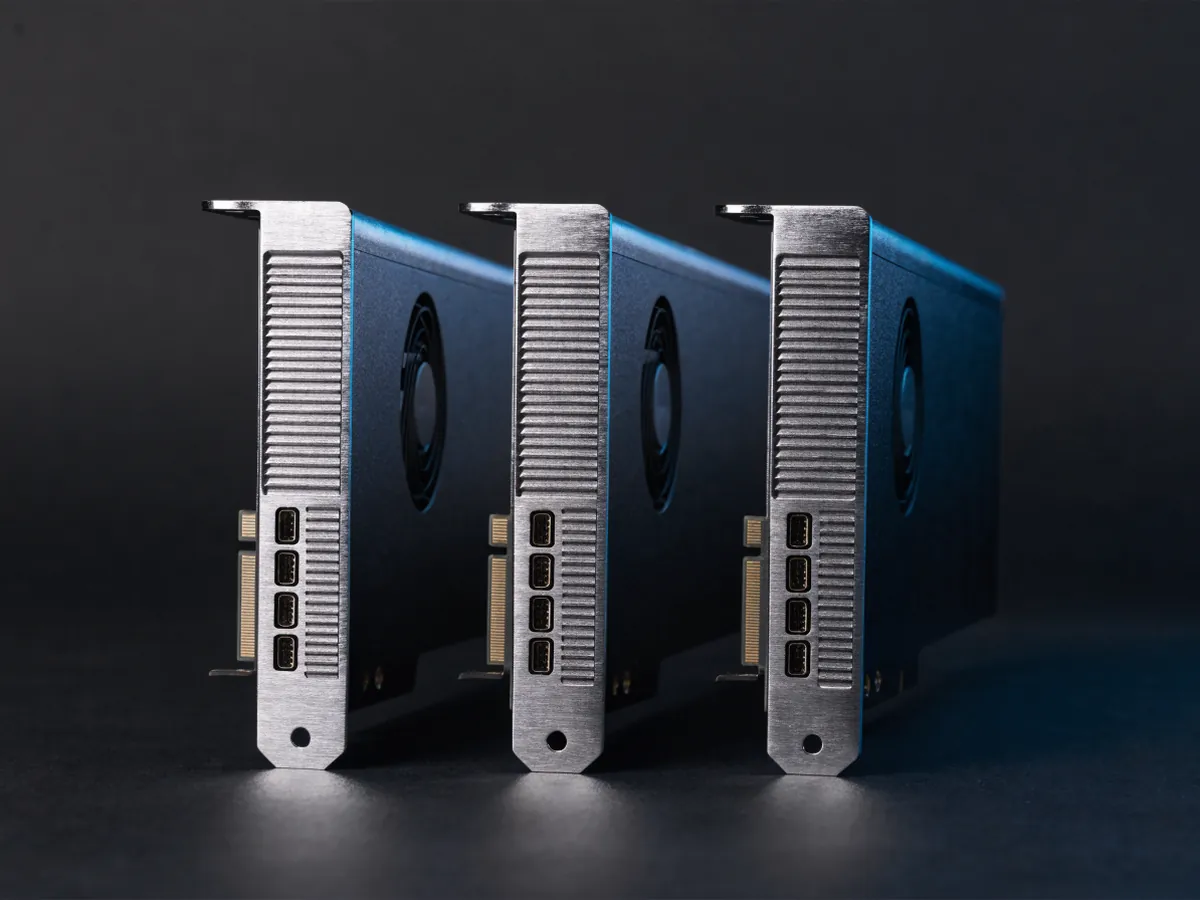 Three slim single slot workstation graphics cards standing upright, each bracket carrying a horizontal row of four mini DisplayPort sockets