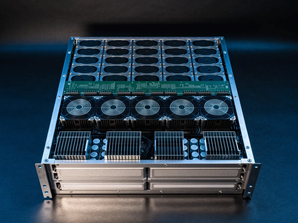 Interior of a four rack unit storage chassis with the top cover off, showing rows of seated hard drives, a green expander backplane board and a fan wall