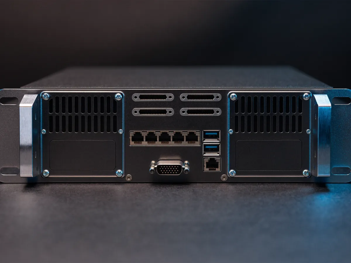 Rear of a two rack unit network attached storage unit showing ethernet ports on expansion card brackets, USB and video connectors and two power supply modules